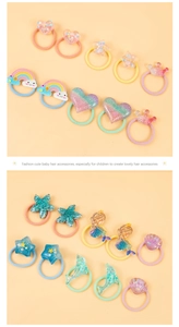 Detail of colorful children hair ties with acrylic heart, star, and rainbow glitter charms