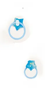Macro detail of a blue star resin hair tie with glitter and protective soft back pad