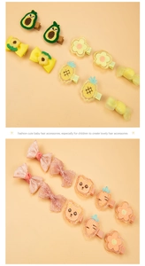 Detail showing embroidered avocado, pineapple, and floral fabric hair clips for kids