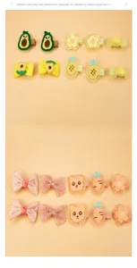 Detail of assorted handmade kids hair clips with cute fabric fruit and animal patterns