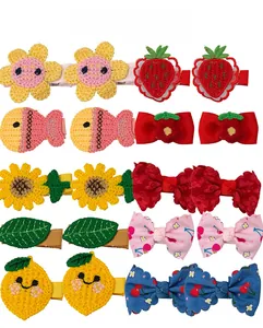 Flat lay display of 10 pairs of knitted flower, fruit, and animal hair clips for girls