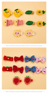 Detail of colorful knitted kids hair clips set with lemon sunflower and bow designs