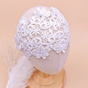 Detail shot of white lace floral headband for baby girls with hollow flower embroidery