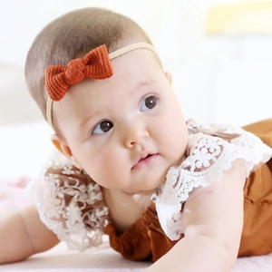 Close-up of orange waffle texture bow on a soft nylon baby headband for infants