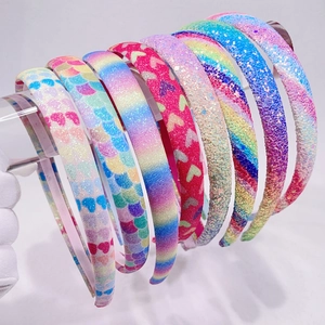 Detail showing various glitter headband styles with rainbow gradients and heart patterns