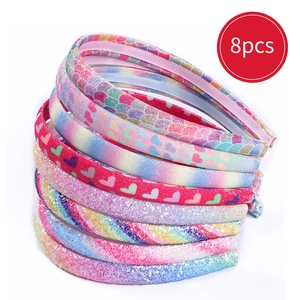 Close-up of 8pcs glitter rainbow headbands for kids with heart and scale patterns