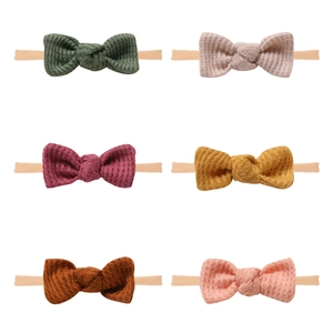 Detail showing 6-color set of waffle knit baby headbands with nylon bands