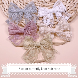 Detail view of 5-color lace butterfly knot hair ties for babies in soft pastel shades