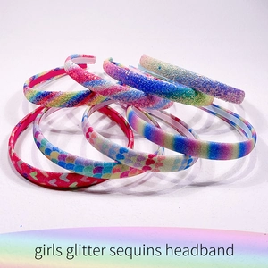 Detail showing various glitter and sequin patterns on colorful girls' headbands