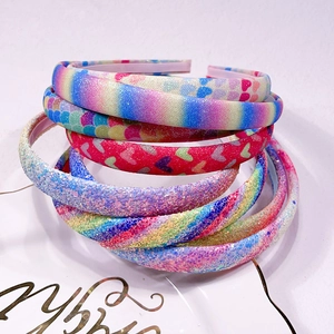 Detail of glitter headbands set with rainbow gradients and sparkling heart designs