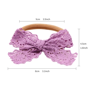 Purple lace bow baby headband with elastic nylon band and cutout lace details
