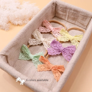 Detail view of 6-pack baby bow headbands set with crochet lace and elastic nylon band