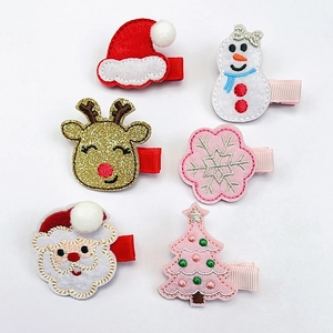 Detail showing set of six Christmas hair clips with embroidery for kids festive dress up