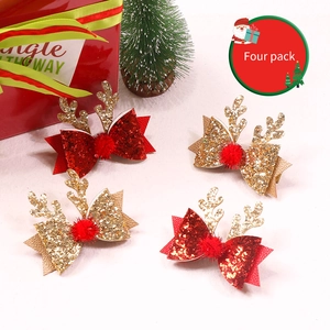 Détail de lot de 4 pinces à cheveux bois de renne de Noël avec pompons rouges et nœuds brillants