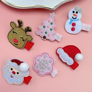 Detailed set of six Christmas hair clips featuring Santa, reindeer and trees on pink background