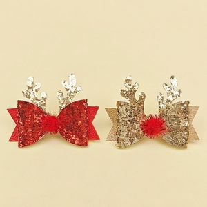 Détail des pinces à cheveux de Noël avec nœuds et bois de renne rouges et dorés