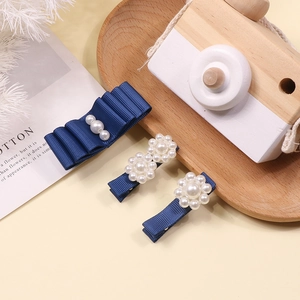 Three-piece girls navy blue ribbon bow hair clips set with artificial pearl accents