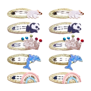 10-piece kids hair clips set with animal embroidery, crowns, and rainbows on gold glitter base
