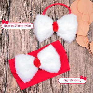 Detail of red nylon baby headband with large white plush bow and high elasticity feature