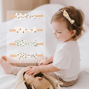 Detail of floral baby headbands showing soft cotton bows and elastic nylon bands