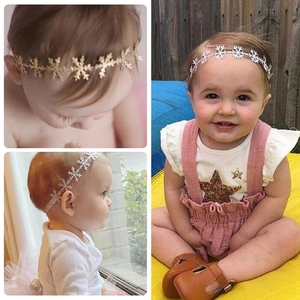 Elastic baby headband with metallic hollow snowflake patterns in gold and silver colors