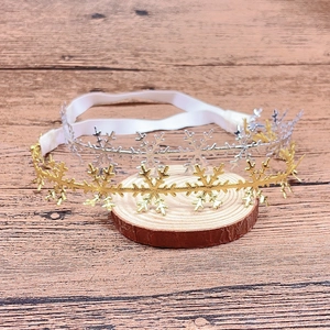 Detail of gold and silver snowflake headbands for babies with elastic white bands