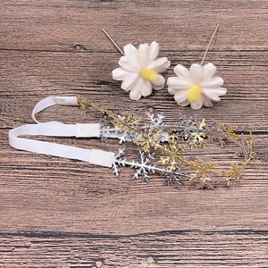 Detailed view of elastic baby headbands with gold and silver hollow snowflake accents