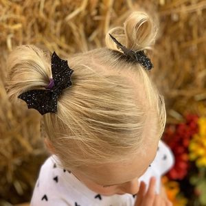 Glittery black bat wing hair clips for girls, perfect for Halloween festival accessory