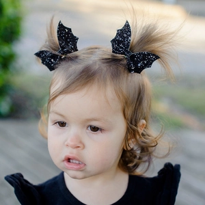 Glittery black bat wing hair clips for girls, perfect for Halloween party hairstyles