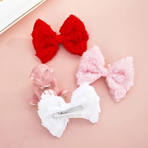 Baby lace rose flower hair clips set in red, pink, and white on pink background