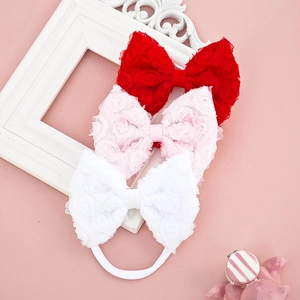 Detailed macro view of three lace rose floral bow headbands in red, pink and white colors
