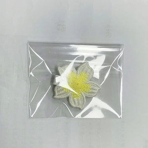 Detail view of a handmade white crochet flower hair clip on a nylon headband for girls