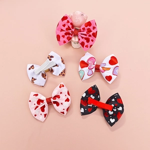 Detail of five-piece bow hair clip set featuring heart prints and leopard patterns