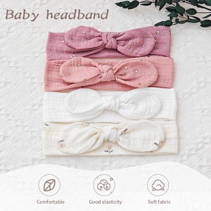 Detail view of 4-pack soft cotton baby headbands with bow design in various floral colors