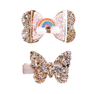 Glittery gold butterfly hair clips for girls with rainbow and cloud decorative details