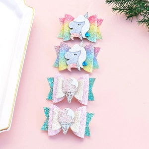 Detail of glitter unicorn and ice cream hair clips in pastel pink and mint green