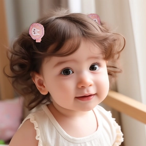 Close-up of pink sequined round hair clips with cute rabbit embroidery on toddler