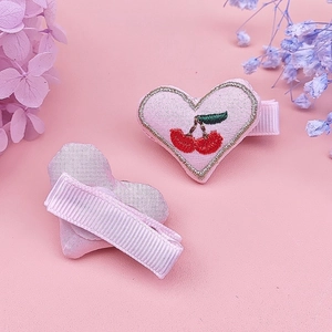 Pink heart-shaped fabric hair clips with red cherry embroidery and gold trim for girls