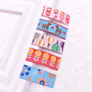 Detail of five assorted floral and animal embroidery patches for kids' hair clips