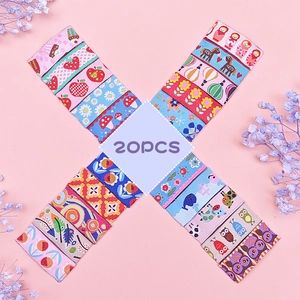 Flat lay of 20pcs children's hair clips with colorful cartoon patterns and floral embroidery
