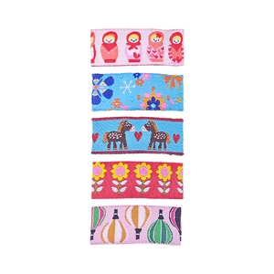 Close-up of colorful embroidered hair clips with floral and cartoon animal patterns