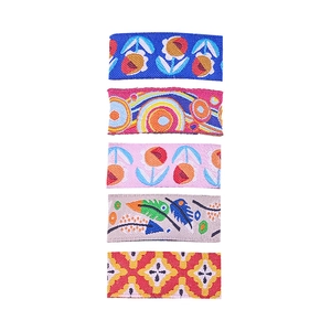 Close-up of colorful embroidered fabric hair clips with floral and geometric patterns