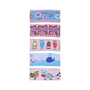 Close-up of embroidered hair clips showing detailed floral and cartoon animal patterns