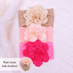 Three-pack soft nylon baby headbands with large fabric flowers for infants aged 0-3 years
