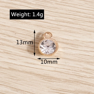 Close-up of clear crystal pendant with gold metal rim and 10mm size specifications