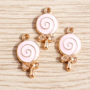 Pink enamel lollipop charms with gold spiral patterns and tiny bows for DIY jewelry