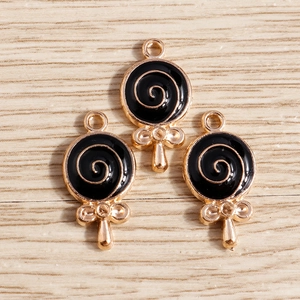 Three gold alloy lollipop charms with black enamel swirl and bow detail for DIY jewelry