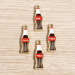 Detail view of miniature alloy cola bottle pendants with red and white enamel on wood