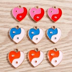 Detail of heart-shaped yin yang alloy pendants with colorful enamel for DIY jewelry making
