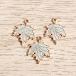 Golden pearlescent maple leaf charms with white enamel inlay for DIY jewelry crafts